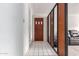 Hallway features a white tiled floor, paneled wall and a dark wood entry door at 2806 W Marshall Ave, Phoenix, AZ 85017