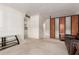 Bright living area featuring neutral carpeting, white walls, and a built-in divider at 2806 W Marshall Ave, Phoenix, AZ 85017