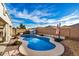 Gorgeous backyard pool with rock features, surrounded by low-maintenance landscaping at 29983 W Fairmount Ave, Buckeye, AZ 85396