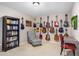 Cozy room with many guitars on the wall and comfy chair with bookcase at 29983 W Fairmount Ave, Buckeye, AZ 85396