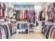 A walk-in closet features custom shelving, ample hanging space, and organized storage for shoes, clothes, and accessories at 29983 W Fairmount Ave, Buckeye, AZ 85396