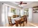 Dining room with large windows, decorative plants, and a ceiling fan at 29983 W Fairmount Ave, Buckeye, AZ 85396