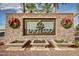 Stone Tartesso entrance sign framed by palm trees and seasonal holiday decor at 29983 W Fairmount Ave, Buckeye, AZ 85396