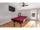 Game room with a pool table, laminate flooring, and a ceiling fan at 29983 W Fairmount Ave, Buckeye, AZ 85396