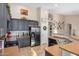 An open kitchen features stainless steel appliances, a gas stove, and dark cabinets with modern hardware at 29983 W Fairmount Ave, Buckeye, AZ 85396