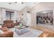 Cozy living room featuring a ceiling fan, hardwood floors, a large window and comfortable seating at 29983 W Fairmount Ave, Buckeye, AZ 85396