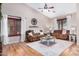 Bright living room featuring hardwood floors, large windows, comfortable seating and neutral paint at 29983 W Fairmount Ave, Buckeye, AZ 85396