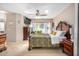 A spacious main bedroom features a ceiling fan, large bed, and bright natural lighting with large windows at 29983 W Fairmount Ave, Buckeye, AZ 85396