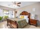 A spacious main bedroom features a ceiling fan, a large bed, and bright natural lighting with large windows at 29983 W Fairmount Ave, Buckeye, AZ 85396