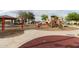 Fun playground with swings, slides, and spring riders, plus a red play area surface, great for Gathering fun at 29983 W Fairmount Ave, Buckeye, AZ 85396