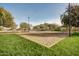 Sand volleyball court with net in the middle surrounded by grass at 29983 W Fairmount Ave, Buckeye, AZ 85396