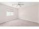 Neutral toned bedroom with neutral carpet, a ceiling fan, and a window with white blinds providing natural light at 3007 N 47Th St, Phoenix, AZ 85018