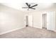 Bedroom featuring neutral carpet, ceiling fan, a closet with sliding doors, and access to an attached bathroom at 3007 N 47Th St, Phoenix, AZ 85018