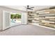 Stylish bedroom with wood accent wall, carpeted flooring, and access to the backyard pool at 3007 N 47Th St, Phoenix, AZ 85018