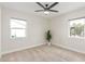 This bedroom offers neutral tones, a ceiling fan, and lots of natural light at 3007 N 47Th St, Phoenix, AZ 85018