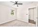 Bright bedroom featuring neutral carpet, a ceiling fan, and a window with a view to the outside at 3007 N 47Th St, Phoenix, AZ 85018