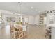 Open-concept dining area featuring a wooden table, rustic chandelier, and modern design elements at 3007 N 47Th St, Phoenix, AZ 85018