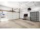 Spacious garage with storage racks and shelving for organization, a scooter, and ample room for parking at 3007 N 47Th St, Phoenix, AZ 85018