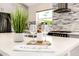 Close-up of the kitchen island featuring white countertops, stylish decor, and modern lighting at 3007 N 47Th St, Phoenix, AZ 85018
