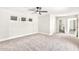 Bright main bedroom featuring neutral carpeting, modern ceiling fan, and natural light from multiple windows at 3007 N 47Th St, Phoenix, AZ 85018