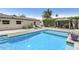 Backyard pool with lounge seating, modern exterior design with lush landscaping for added privacy at 3007 N 47Th St, Phoenix, AZ 85018