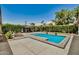 Refreshing backyard pool with a gazebo, a covered patio, lounge seating, and lush greenery for privacy at 3007 N 47Th St, Phoenix, AZ 85018