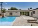 Backyard pool with lounge seating, and modern exterior with seamless access through large glass doors at 3007 N 47Th St, Phoenix, AZ 85018