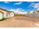 Spacious backyard enclosed with both wood and cinder block fencing, perfect for privacy and customization at 3042 N 87Th Ave, Phoenix, AZ 85037