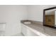 The bathroom offers a large granite-look countertop and white cabinets at 3042 N 87Th Ave, Phoenix, AZ 85037