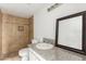 Bathroom featuring updated vanity, granite counters, a mirror, and a tiled shower at 3042 N 87Th Ave, Phoenix, AZ 85037