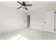 A bright bedroom with an open door, closet and white tile flooring at 3042 N 87Th Ave, Phoenix, AZ 85037