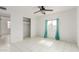 Clean bedroom with ceiling fan, closet, and large window for natural light at 3042 N 87Th Ave, Phoenix, AZ 85037