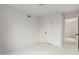 An empty bedroom featuring white walls, white tile flooring, and a closet at 3042 N 87Th Ave, Phoenix, AZ 85037