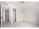 This bedroom features a standard closet with sliding doors, neutral paint, and tile floor at 3042 N 87Th Ave, Phoenix, AZ 85037
