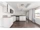 Open kitchen with stainless steel appliances, white cabinets, and granite countertops at 3042 N 87Th Ave, Phoenix, AZ 85037