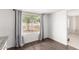 Bright living room with hardwood floors, a large window, and neutral-colored walls at 3042 N 87Th Ave, Phoenix, AZ 85037