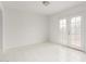 Bright, airy living room featuring white tile flooring and glass patio doors at 3042 N 87Th Ave, Phoenix, AZ 85037