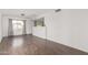 Bright open living room with hardwood floors, neutral walls, and a view of the kitchen at 3042 N 87Th Ave, Phoenix, AZ 85037