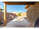 View of the backyard featuring a grill, desert landscaping, block wall, and spacious concrete patio at 306 W Angus Rd, San Tan Valley, AZ 85143