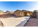 Large backyard featuring low maintenance desert landscaping, block wall, and concrete patio with exterior lighting at 306 W Angus Rd, San Tan Valley, AZ 85143