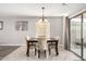 Dining area with a sliding glass door, stylish chairs, and modern chandelier at 306 W Angus Rd, San Tan Valley, AZ 85143