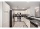 Modern kitchen with stainless steel appliances, tile backsplash, and ample white cabinets at 306 W Angus Rd, San Tan Valley, AZ 85143