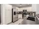 Modern kitchen with stainless steel appliances, dark countertops, and bright white cabinets at 306 W Angus Rd, San Tan Valley, AZ 85143