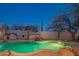 Custom backyard pool features a rock waterfall, built in grill, and desert landscaping at 30600 N Pima Rd # 19, Scottsdale, AZ 85266