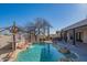 Backyard pool with rock features, desert landscaping, a hot tub, and a covered patio at 30600 N Pima Rd # 19, Scottsdale, AZ 85266