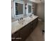 Bathroom featuring modern vanity with double sinks, sleek fixtures, and modern lighting at 30600 N Pima Rd # 19, Scottsdale, AZ 85266