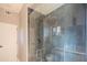 Luxurious shower features gray tiling, a glass door, and modern fixtures, creating a spa-like retreat at 30600 N Pima Rd # 19, Scottsdale, AZ 85266