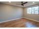 Bright bedroom with hardwood floors and a large window, offering a comfortable and inviting space at 30600 N Pima Rd # 19, Scottsdale, AZ 85266