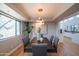 Modern dining room with a stylish light fixture, a large window, and view into the kitchen at 30600 N Pima Rd # 19, Scottsdale, AZ 85266