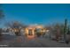 Inviting home exterior showcasing desert landscaping, a paver driveway, and illuminated entry at twilight at 30600 N Pima Rd # 19, Scottsdale, AZ 85266